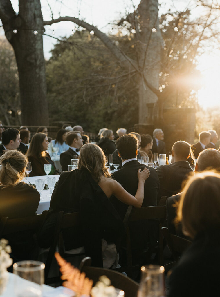 Bride and groom during golden hour listening to toasts at the Virginia House in Richmond, Virginia.