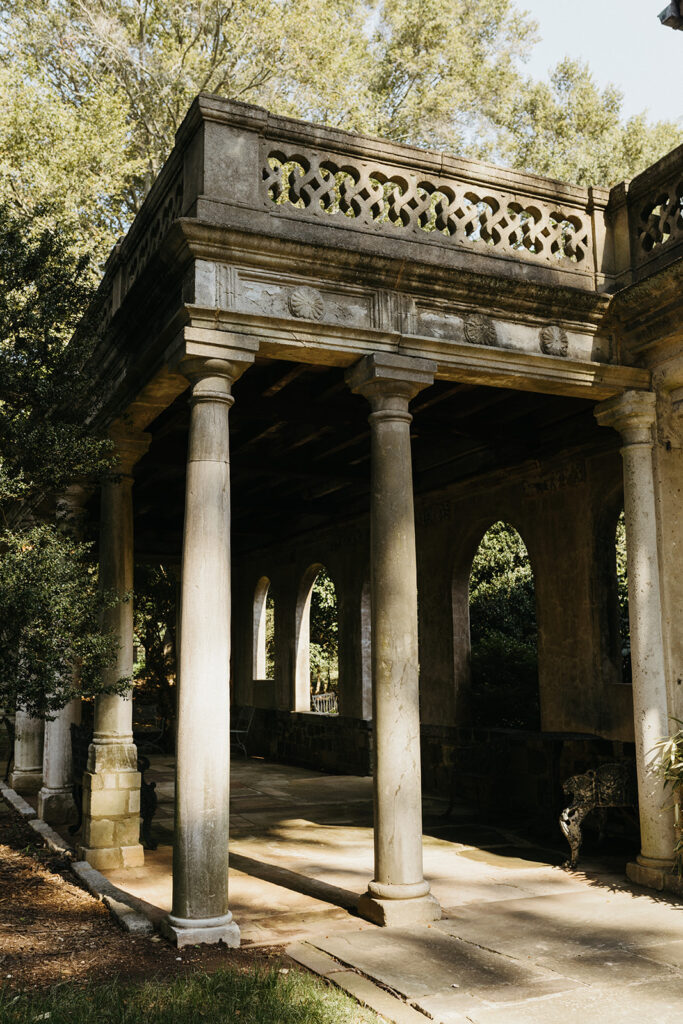 Exterior view of the historic Virginia House wedding venue in Richmond, Virginia, showcasing stone architecture and manicured gardens.