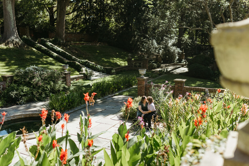 Photo of two brides during their engagement session in the gardens of the Virginia House in Richmond, Virginia