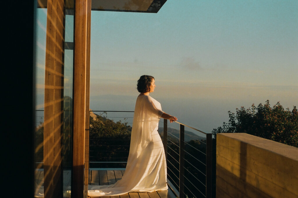 Bride on balcony at the Saddle Peak House in Topanga Canyon during sunset.