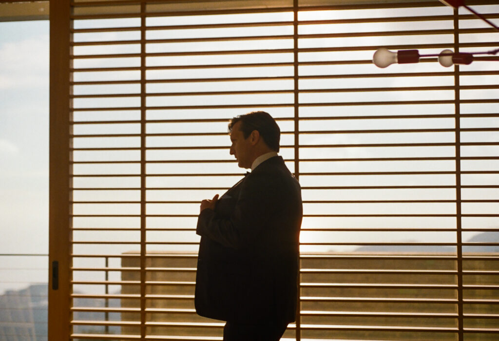 Groom putting on his suit jacket Topanga Canyon Malibu Destination Wedding.