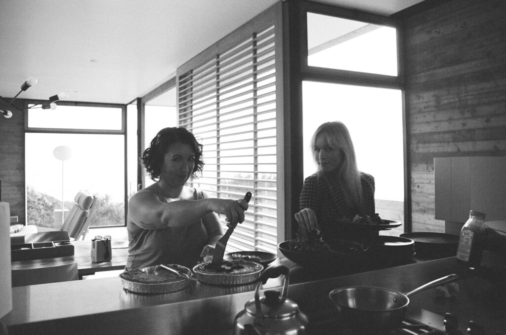 Bride and friend serving themselves lunch. Topanga Canyon Malibu Destination Wedding