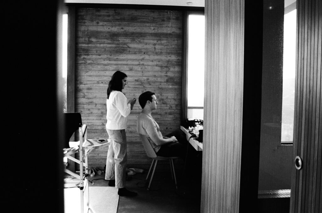 Groom getting hair touch ups by makeup artist. Topanga Canyon Malibu Destination Wedding