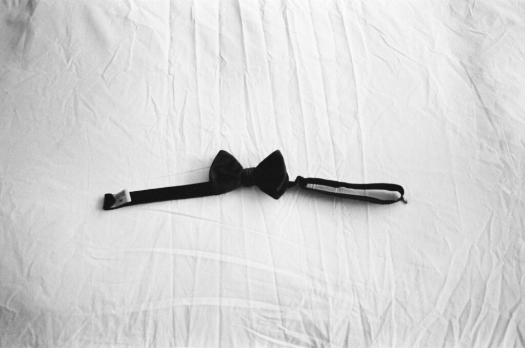 Groom's bow tie on bed. Topanga Canyon Malibu Destination Wedding