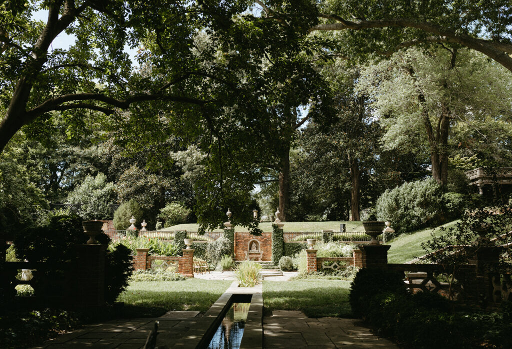 Exterior view of the historic Virginia House wedding venue in Richmond, Virginia, showcasing stone architecture and manicured gardens.