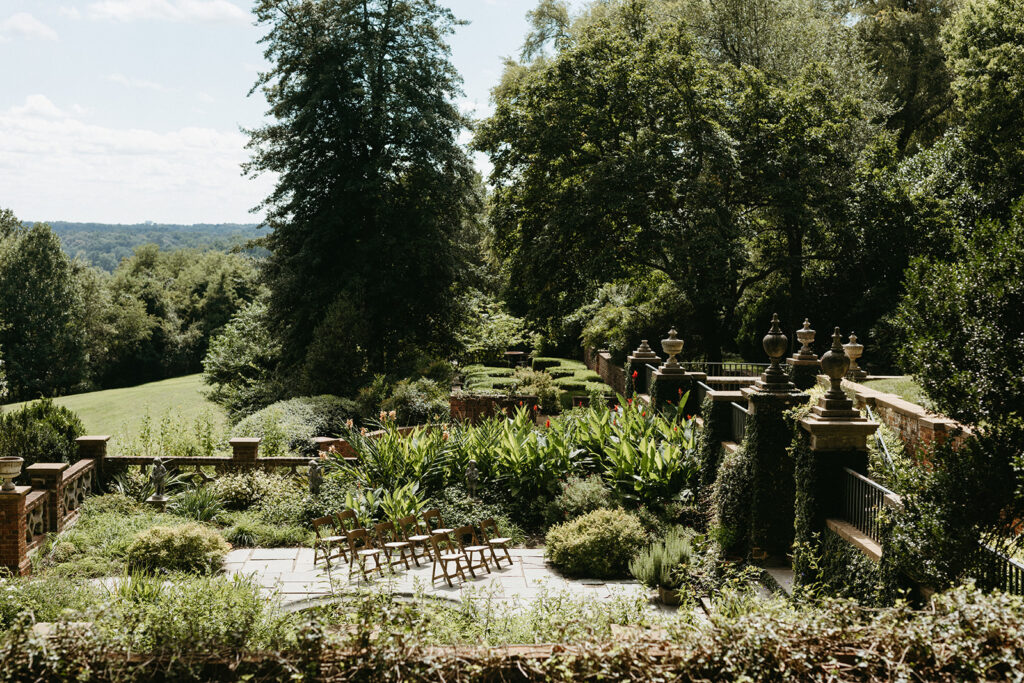 Exterior view of the historic Virginia House wedding venue in Richmond, Virginia, showcasing stone architecture and manicured gardens.