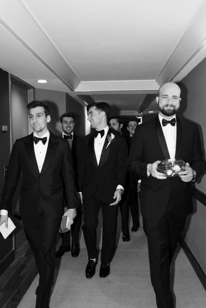 Groom and his groomsmen walking to the elevator at the Hyatt in Washington DC to go to the Larz Anderson House. 