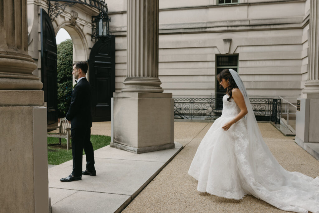Bride walking from the Larz Anderson House entrance to meet her groom for a first look.