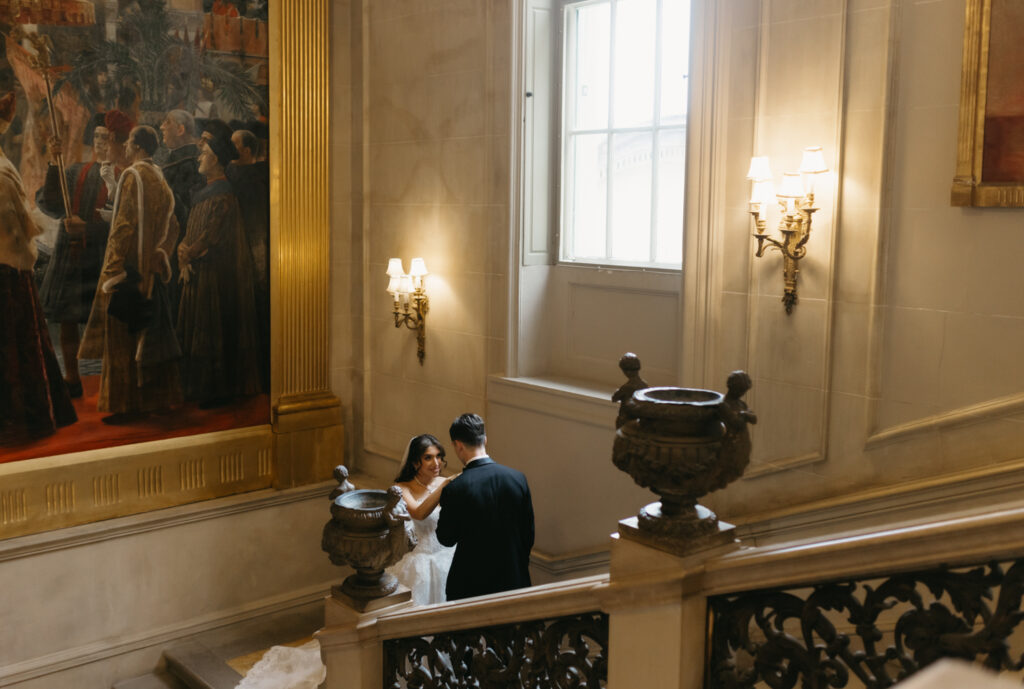 Fine art Portrait of bride and groom walking up the marble staircase at Larz Anderson House in Washington DC