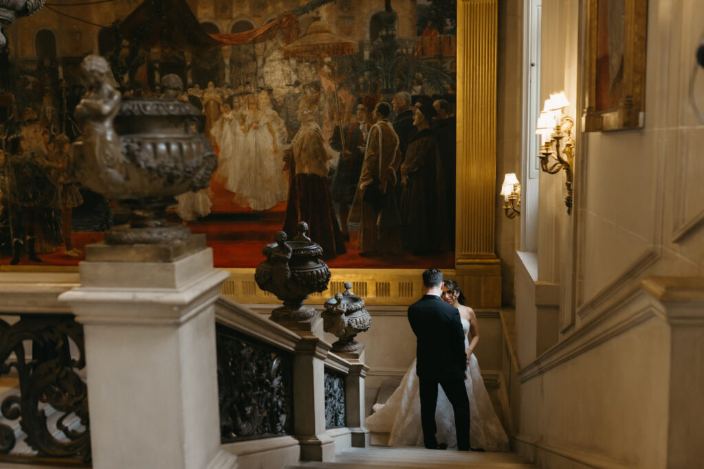 Fine art Portrait of bride and groom walking up the marble staircase at Larz Anderson House in Washington DC