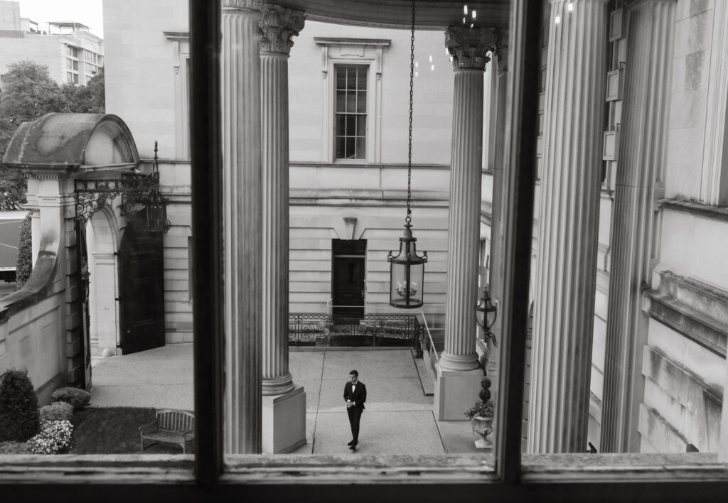 Bridal party in formal black tie attire posing in front of the Larz Anderson House
