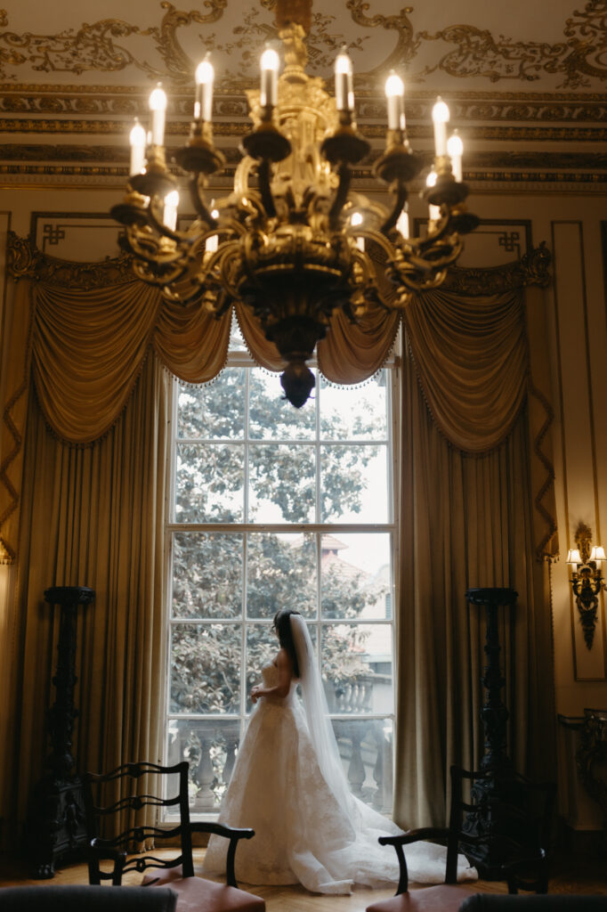 Bride having a quiet moment in the library room at the Larz Anderson House
