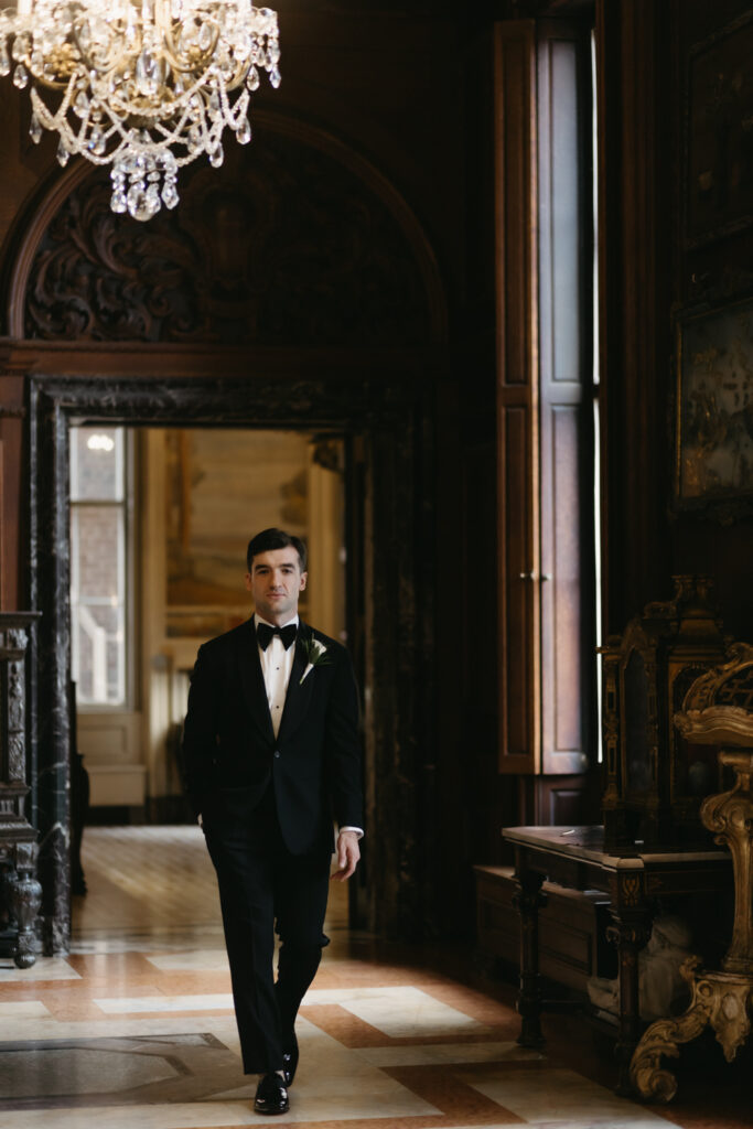 Portrait of groom walking in the Larz Anderson House in Washington DC 