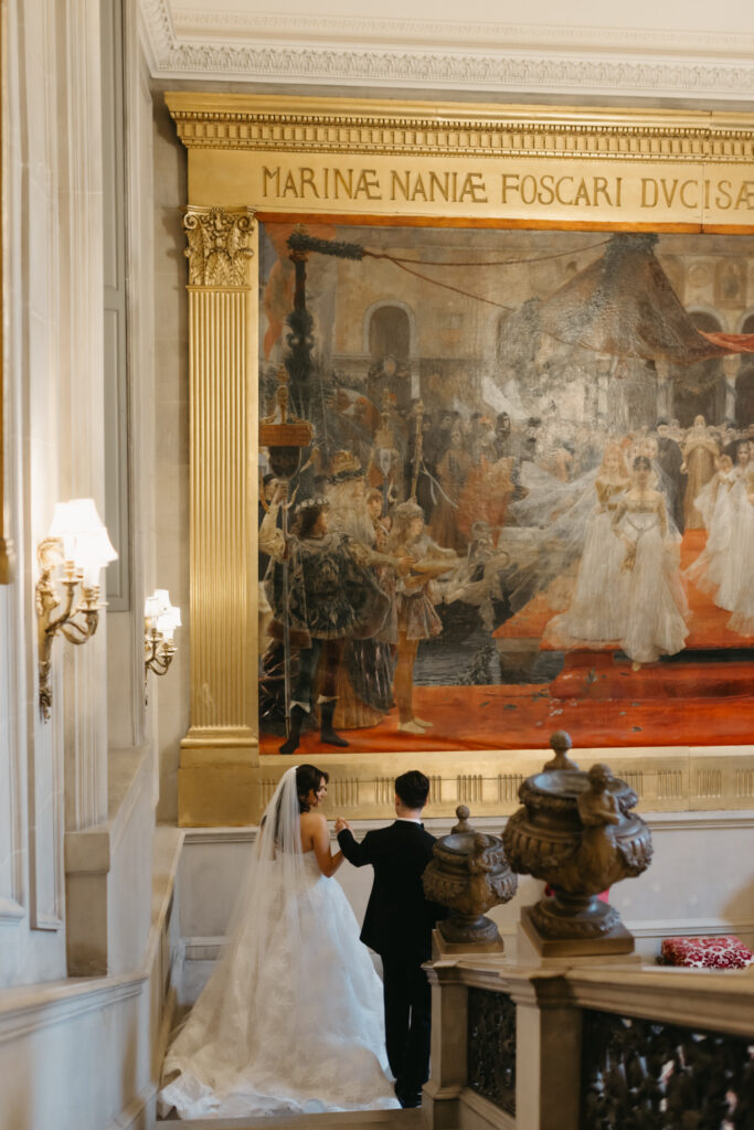 Fine art Portrait of bride and groom walking up the marble staircase at Larz Anderson House in Washington DC