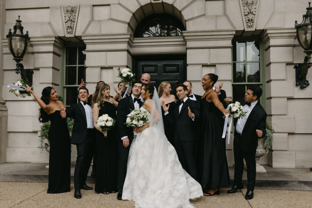 Bridal party in formal black tie attire posing in front of the Larz Anderson House
