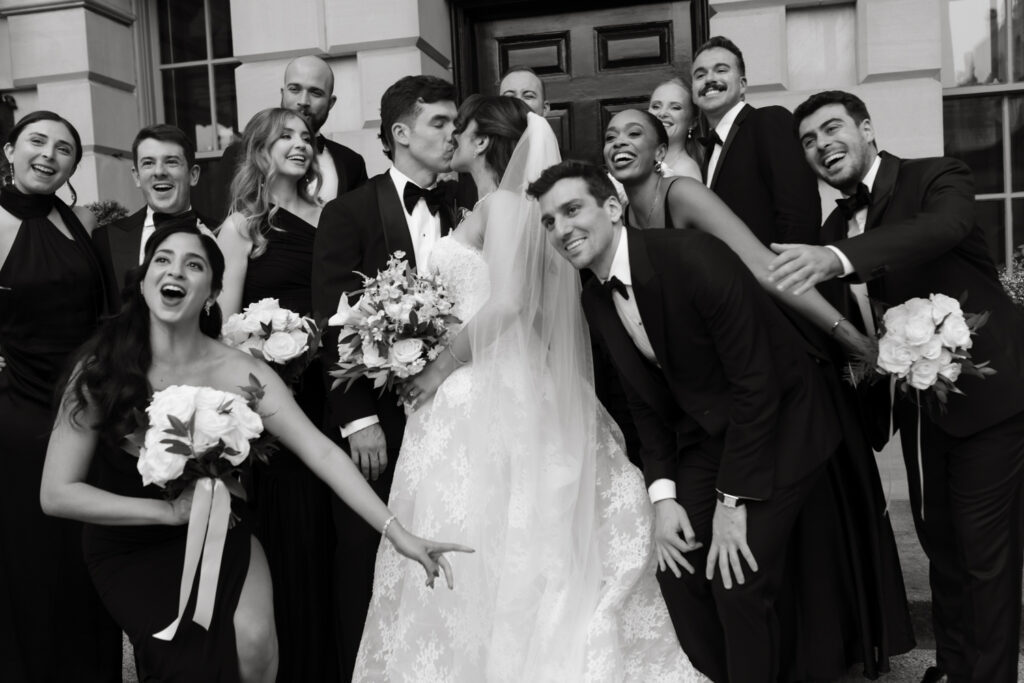 Bridal party in formal black tie attire posing in front of the Larz Anderson House

