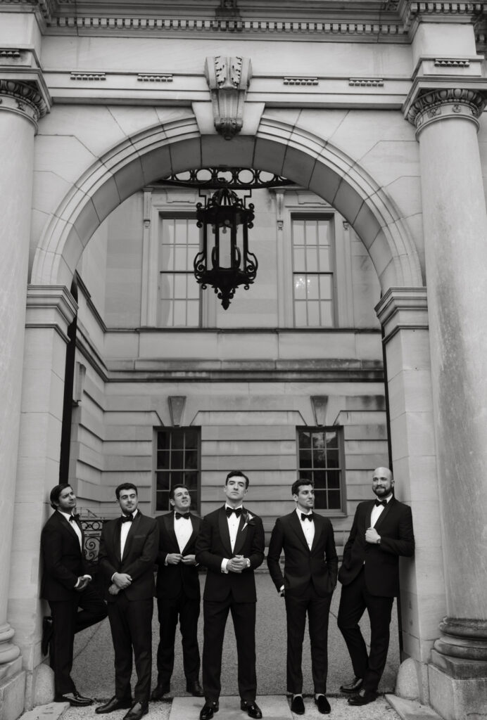 Groom and Groomsmen in formal black tie attire posing in front of the Larz Anderson House