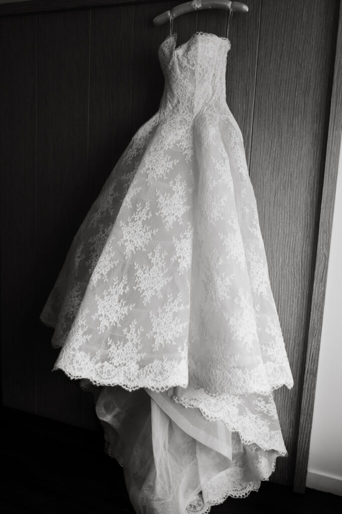 Brides princess wedding gown hanging on a door in the brides getting ready suite at the Hyatt Hotel in Washington DC.