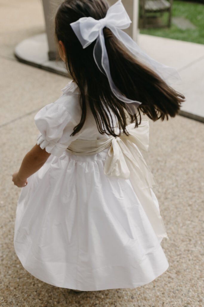 Flower girl spinning and playing at Larz Anderson House DC Wedding