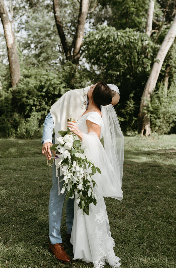 Abingdon Virginia summer wedding — Jewish wedding ceremony on the Creeper Trail, intimate moment between bride and groom hugging after their ceremony.
