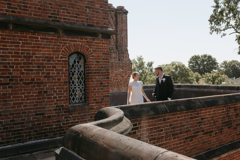 Bride and groom portrait on brick balcony at the Branch Museum in Richmond, Virginia. 