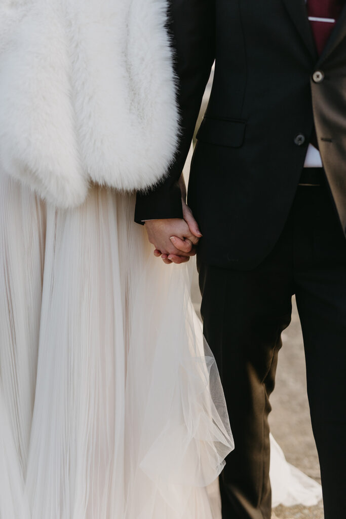 Bride and Groom holding hands on their elopement day at Libby Hill in Richmond, Virginia at sunset.