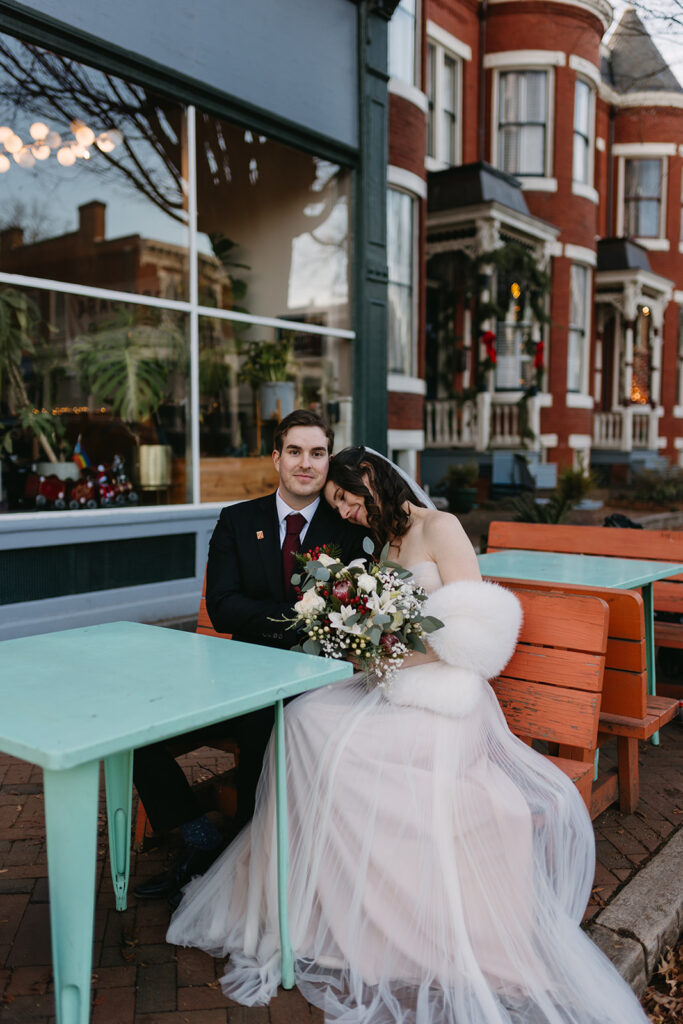 Bride and Groom sitting on bench in front of Riverbend Roastery in the Church Hill neighborhood of Richmond, Virginia.