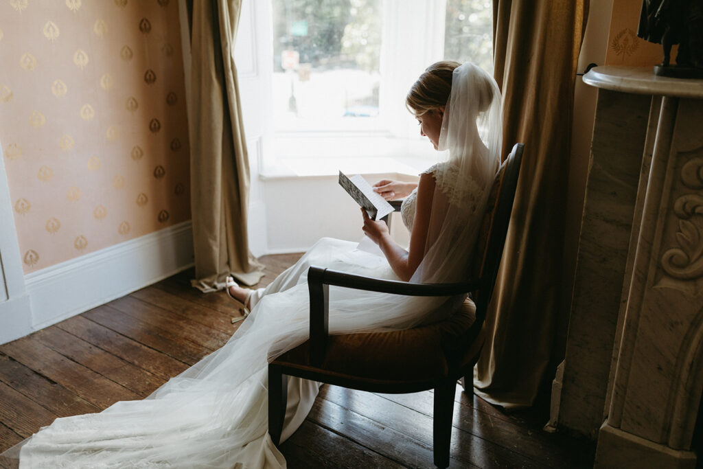 Bride reading a sweet letter in the getting ready suite at Linden Row on her wedding day.