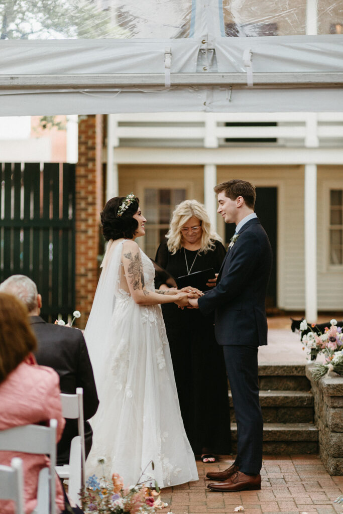 Bride and groom at their ceremony in the courtyard at the Linden Row.