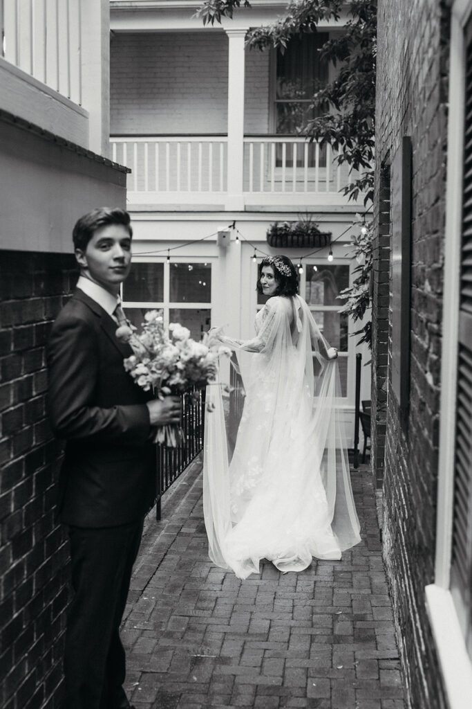 Bride and groom portraits in a brick pathway in the courtyard at the Linden Row in Richmond, Virginia.