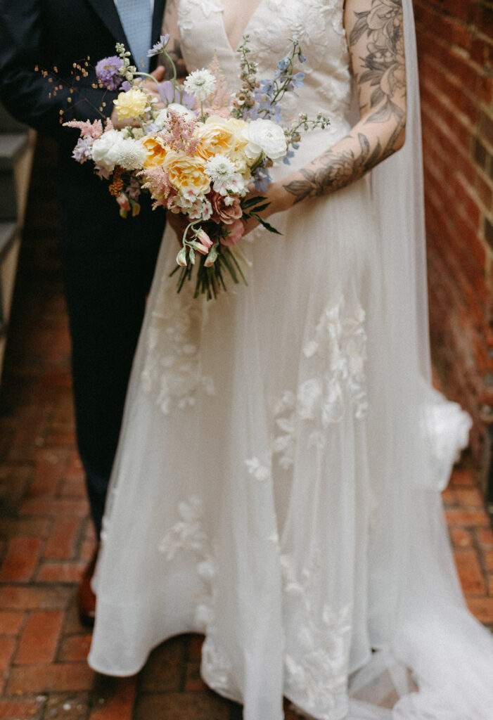 Bride and groom portraits in a brick pathway in the courtyard at the Linden Row in Richmond, Virginia.