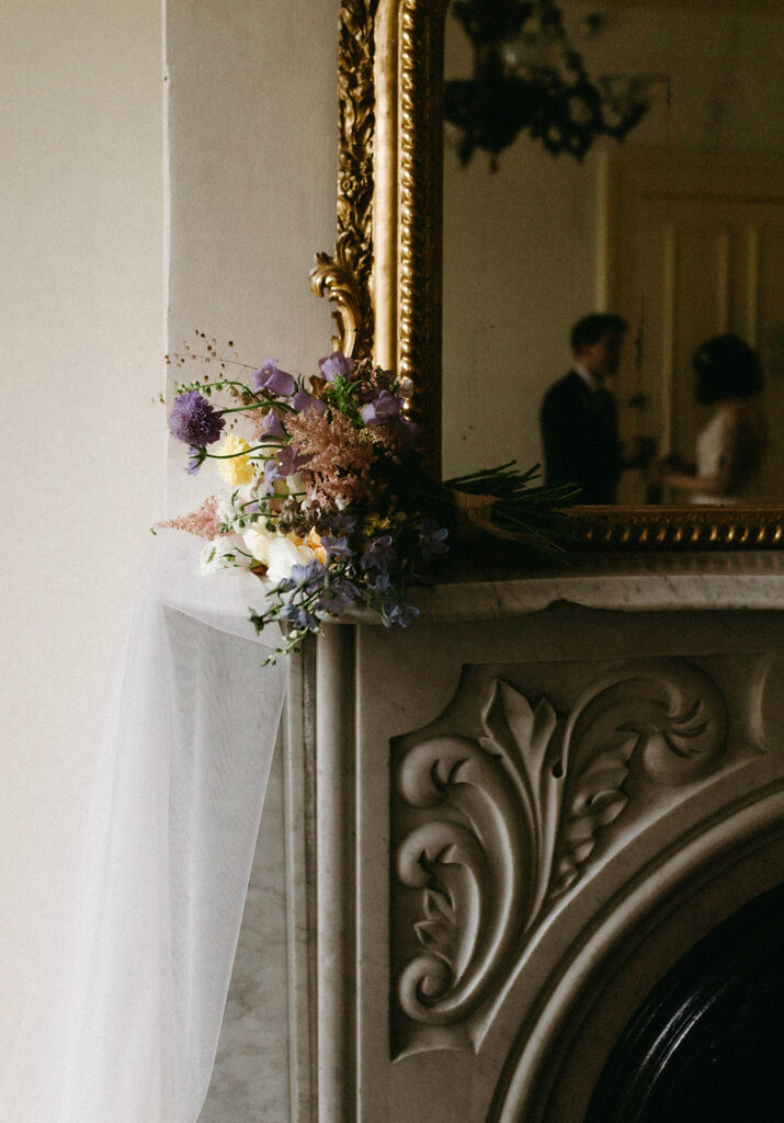 Bridal bouquet by Hazel Witch Farm in Richmond, Virginia, photographed on a vintage mantle at Linden Row. 