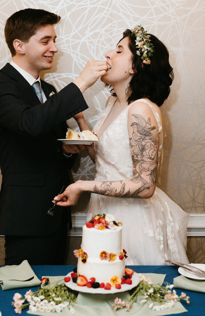 Bride and Groom cutting their cake during their wedding reception at the Linden Row.