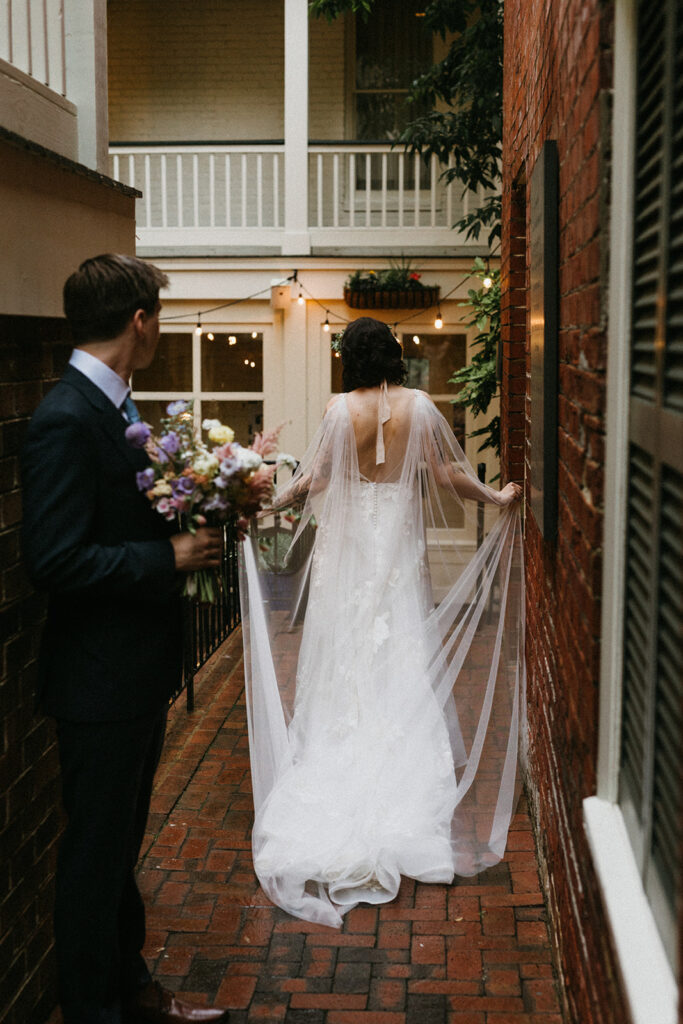 Bride and groom portraits in a brick pathway in the courtyard at the Linden Row in Richmond, Virginia.