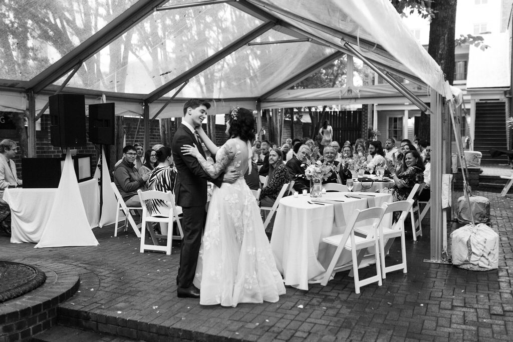 Bride and groom sharing their first dance in front of guests at the Linden Row in Richmond Virginia Historic Wedding Venue.