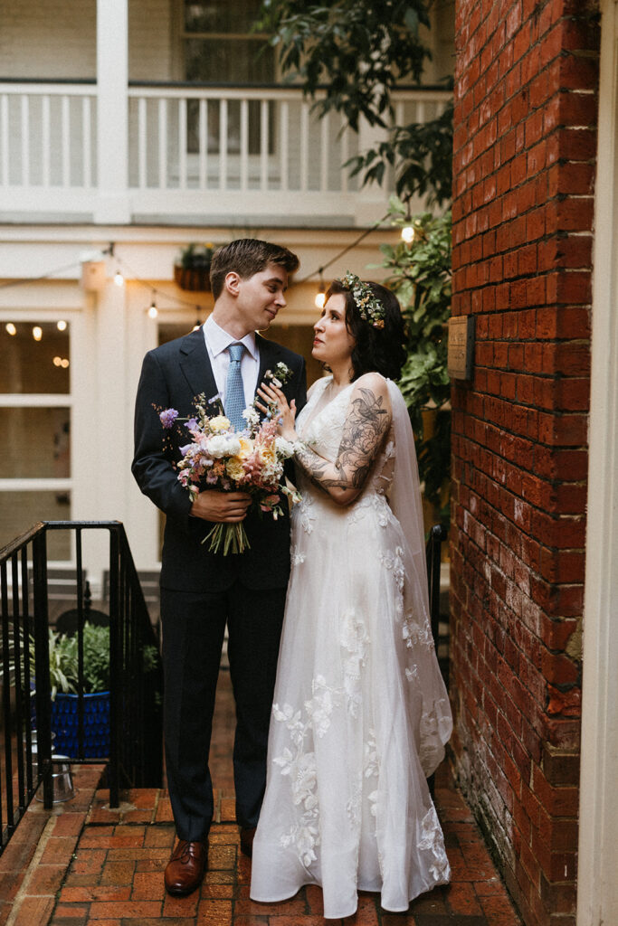 Bride and groom portraits in a brick pathway in the courtyard at the Linden Row in Richmond, Virginia.