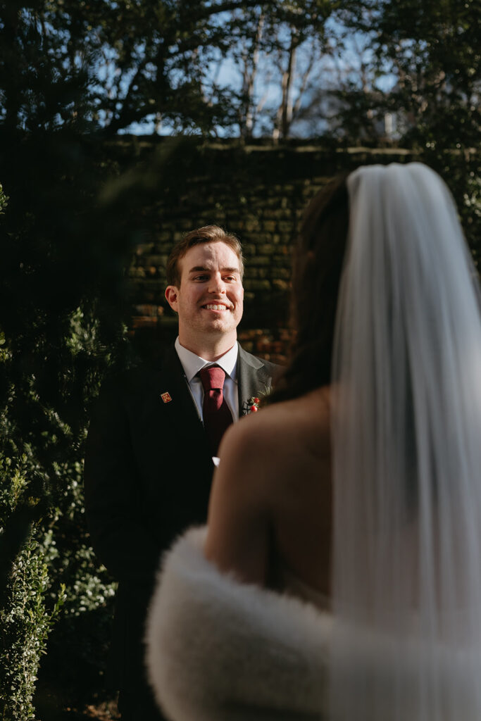 Groom listening to bride say vows at their Richmond winter micro wedding.