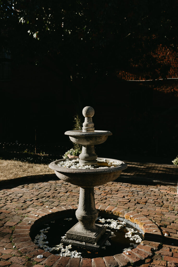 Courtyard fountain with rose petals at the Poe Museum in Richmond, Virginia.