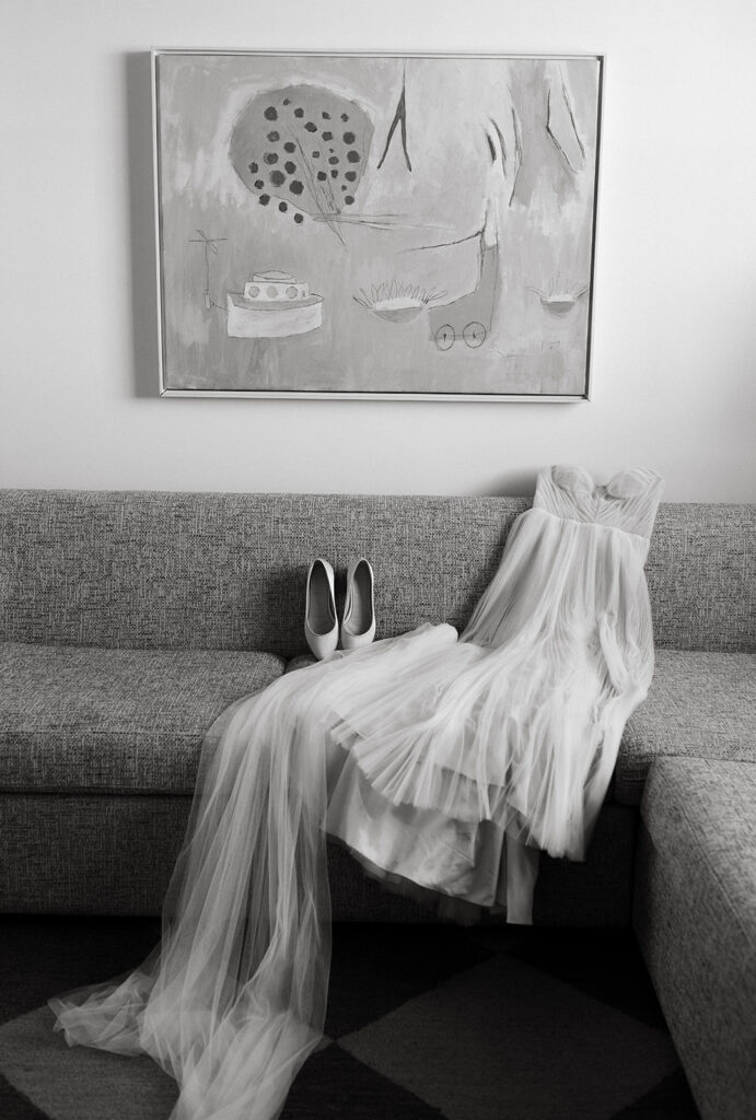 Black and white image of a bride's dress and shoes at Quirk Hotel in Richmond, Virginia.