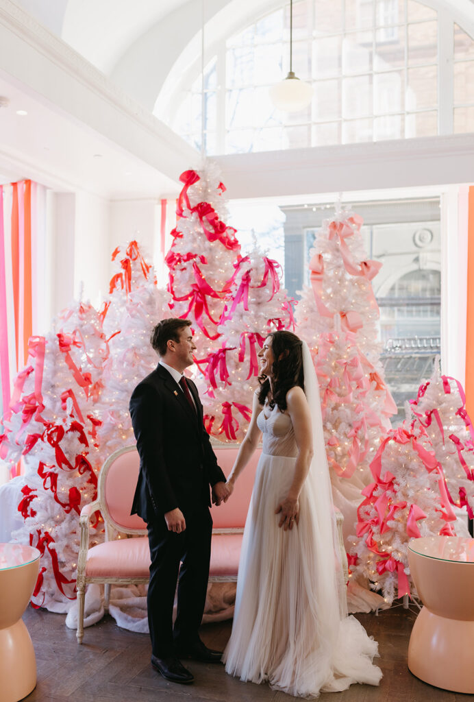 Richmond winter micro wedding at the Quirk hotel. Bride and groom standing in front of the pink tree.