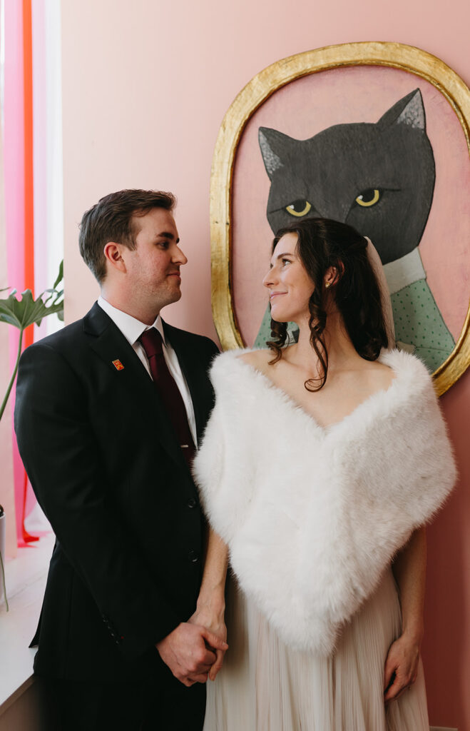 Portrait of Bride and Groom holding hands in the Quirk Hotel before their Richmond winter micro wedding.