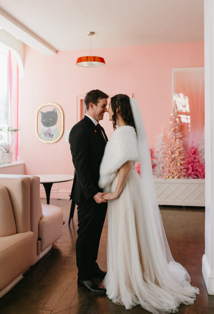 Portrait of Bride and Groom holding hands in the Quirk Hotel before their Richmond winter micro wedding.