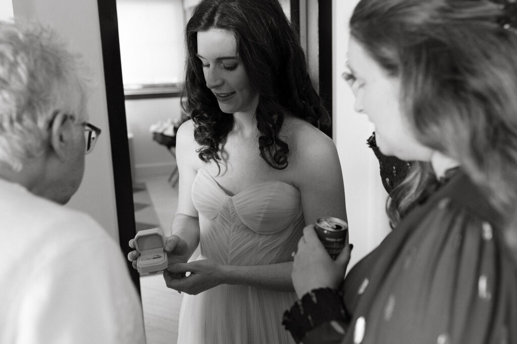 Bride showing her ring to her family