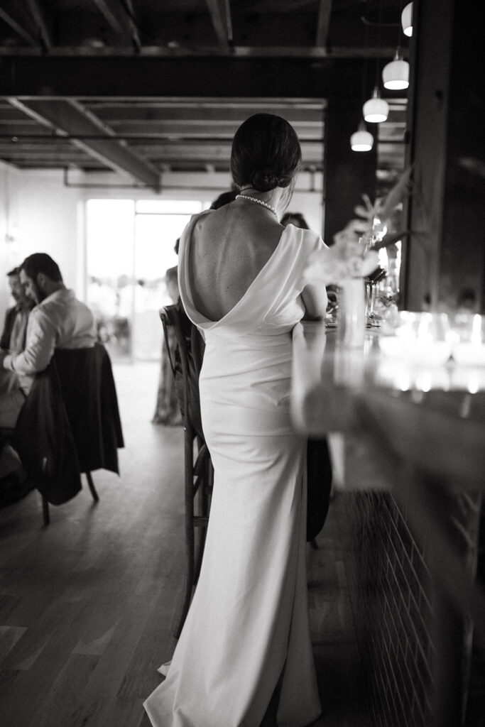 Abingdon Virginia summer wedding — Bride standing at bar and interacting with guests.
