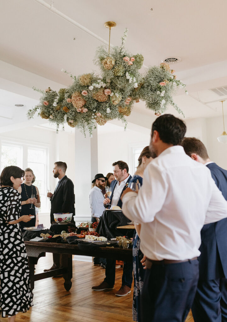 Cocktail Hour at Summers Roof and Cellar, featuring family-style dining and summer floral decor.