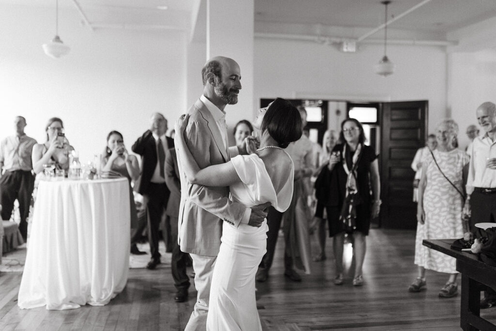 Bride and Groom share first dance floor at Summers Roof and Cellar, filled with laughter and dancing.