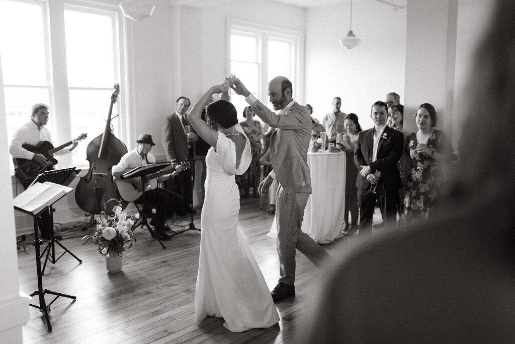 Bride and Groom share first dance floor at Summers Roof and Cellar, filled with laughter and dancing.