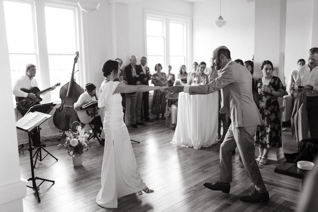 Bride and Groom share first dance floor at Summers Roof and Cellar, filled with laughter and dancing.