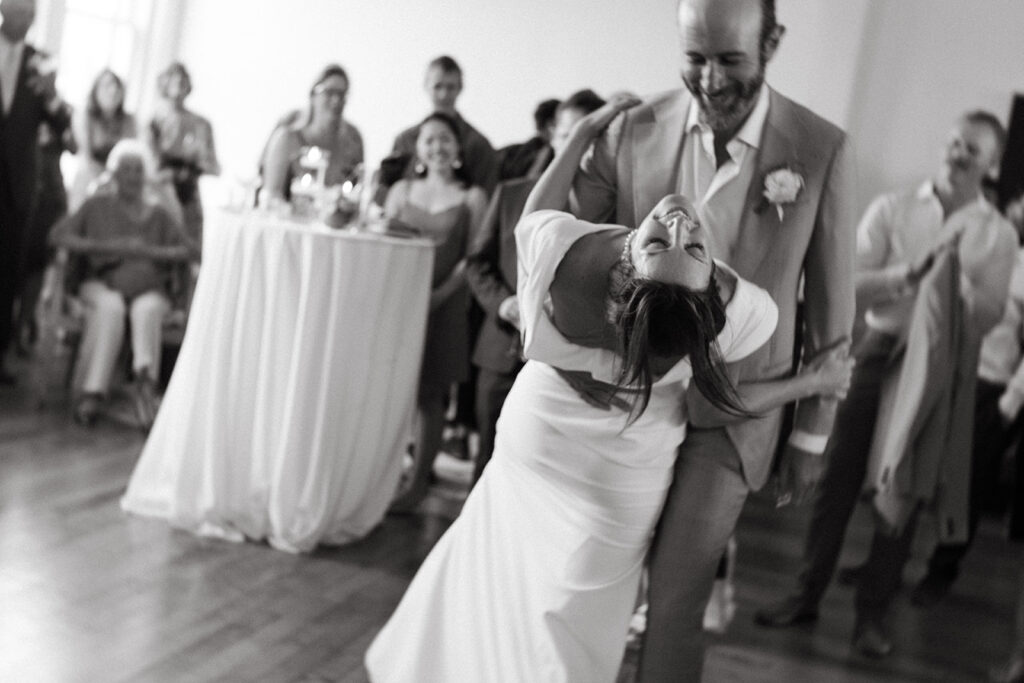 Bride and Groom share first dance floor at Summers Roof and Cellar, filled with laughter and dancing.
