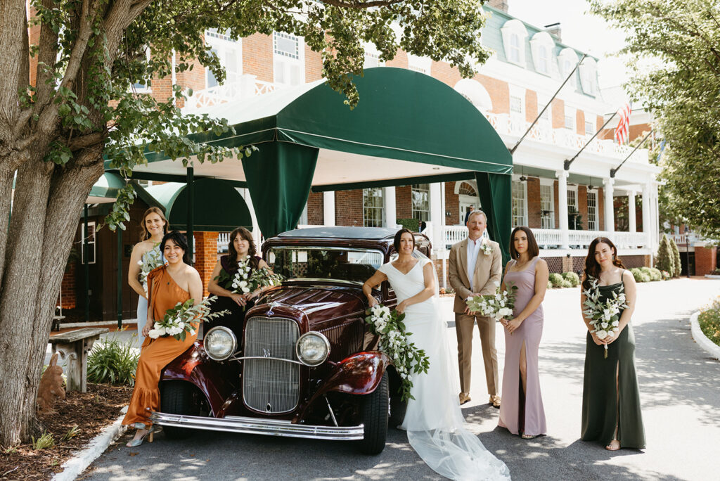 Abingdon Virginia summer wedding — bridal party posing by a vintage car outside the Martha Washington Inn, capturing fun and timeless elegance.